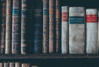 Wallpaper Assorted Books in Brown Wooden Bookshelf