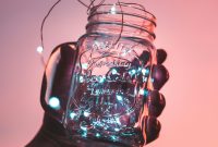 Wallpaper Person Holding Clear Glass Mason Jar with Strip Lights Inside