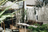 Wallpaper White Table with Brown Wicker Chair Beside Plants