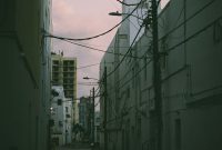 Wallpaper A Dark Alley Way with Power Lines Above