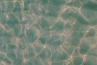 Wallpaper The Water is Reflecting the Sunlight on the Sand