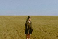 Wallpaper Woman in Black Coat on Green Grass