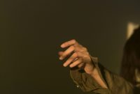 Wallpaper Person in Brown Jacket Holding Black Textile