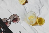 Wallpaper A Book, Sunglasses, and Lemons on a Bed