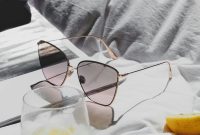 Wallpaper A Pair of Sunglasses on a Bed