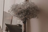 Wallpaper A Vase Filled with Baby’s Breath on a Bed