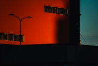 Wallpaper A Red Building with a Streetlight
