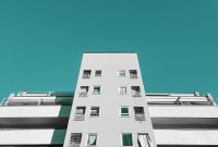 Wallpaper A Tall White Building with Balconies and Windows