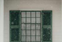 Wallpaper A White House with a Green Window and Shutters