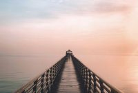 Wallpaper A Long Pier Stretching Out Into the Ocean