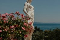 Wallpaper Statue on Ledge Overlooking Water