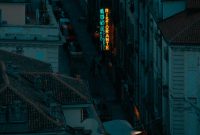 Wallpaper A City Street at Night with Neon Sign