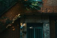 Wallpaper A Tall Brick Building with a Green Door