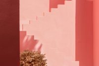 Wallpaper A Pink Building with a Potted Plant
