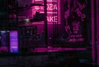 Wallpaper A Neon Sign is Lit Up in the Dark
