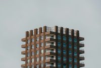 Wallpaper A Tall Brown Building with Lots of Windows