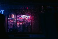 Wallpaper A Dark Room with a Neon Sign and a Window