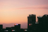 Wallpaper A View of a City Skyline at Sunset