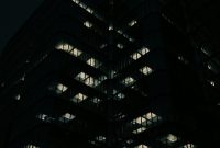 Wallpaper A Very Tall Building Lit Up at Night