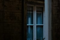 Wallpaper A Window with a House Reflection