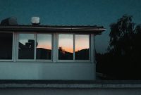 Wallpaper A House with a Roof and Windows at Night