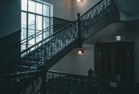 Wallpaper An Elegant Staircase Inside a Dimly Lit Building